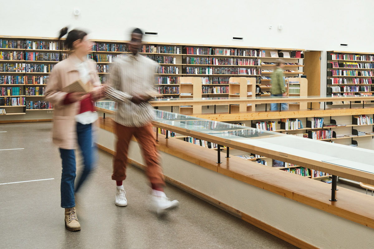 Students walking through a university library